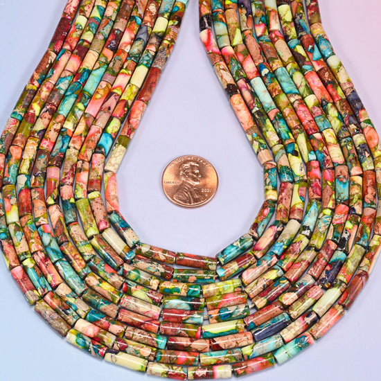 Close-up horizontal row of jasper tube beads showing the twisted texture and color variation of the strand against a lavender backdrop.