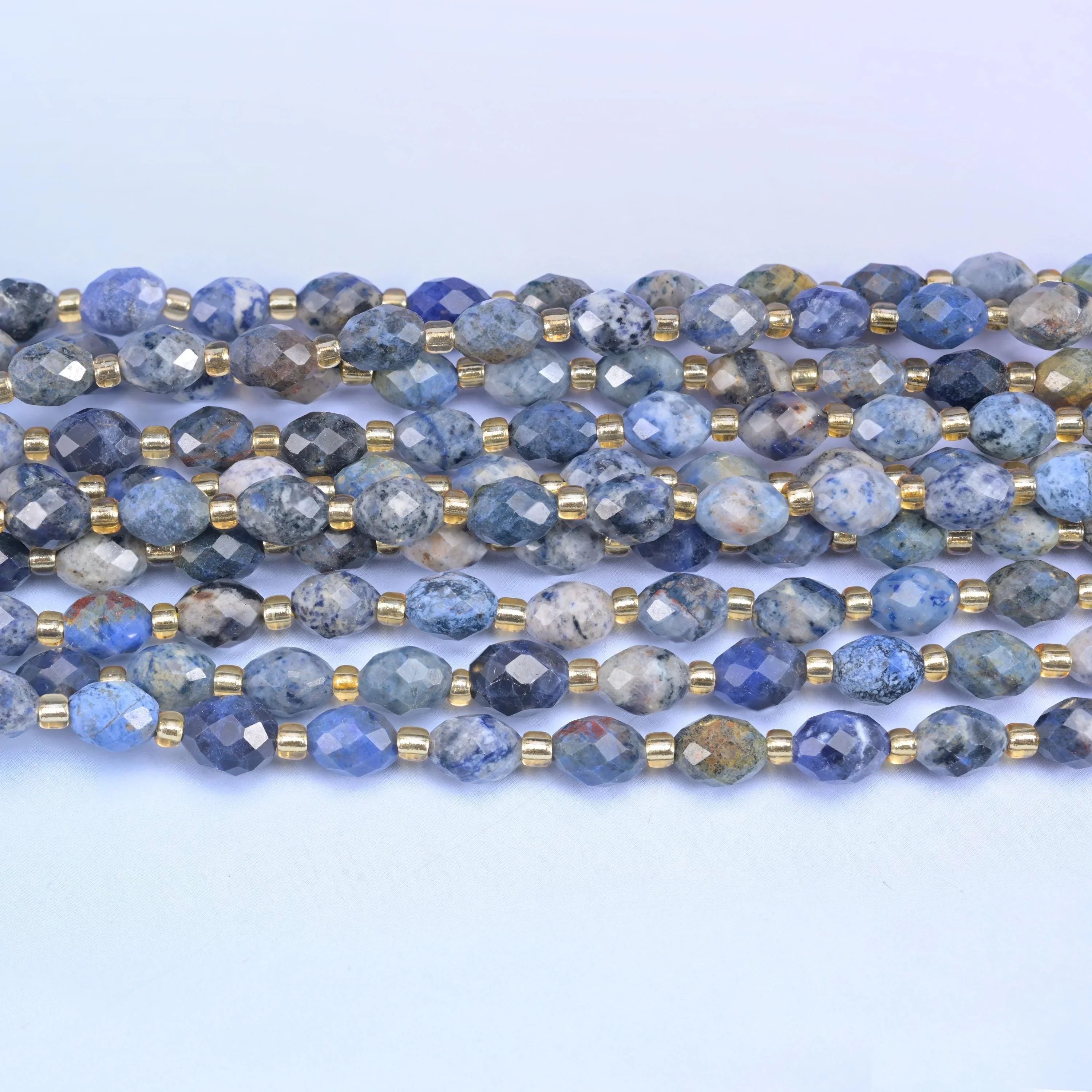 Faceted rice barrel cut sunset dumortierite beads