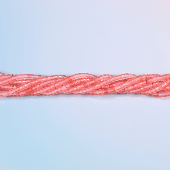 Strands of melon quartz faceted heishi disc beads twisted together in a horizontal row