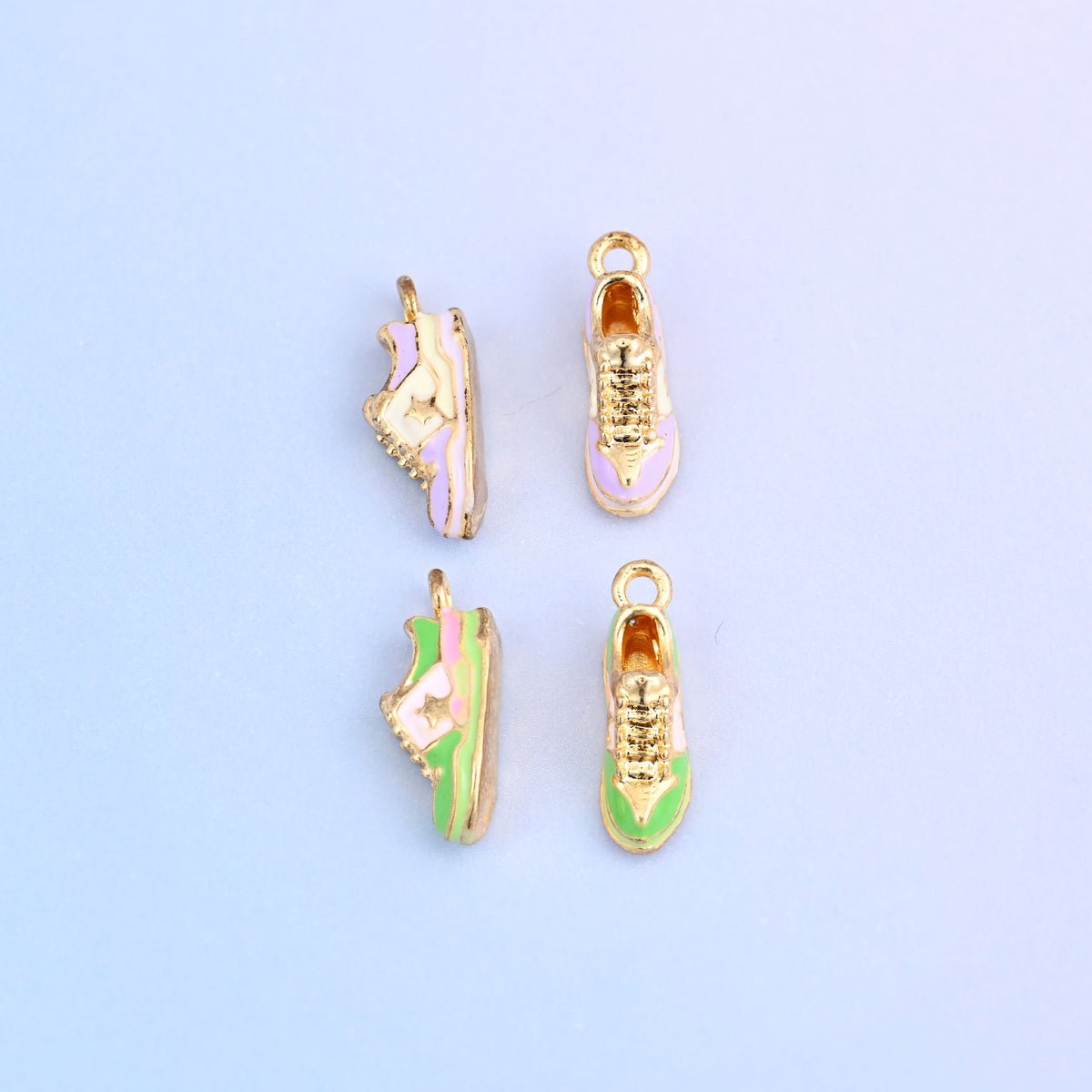 Four sneaker charms, two seen from the side and two from above showing the laced tops.