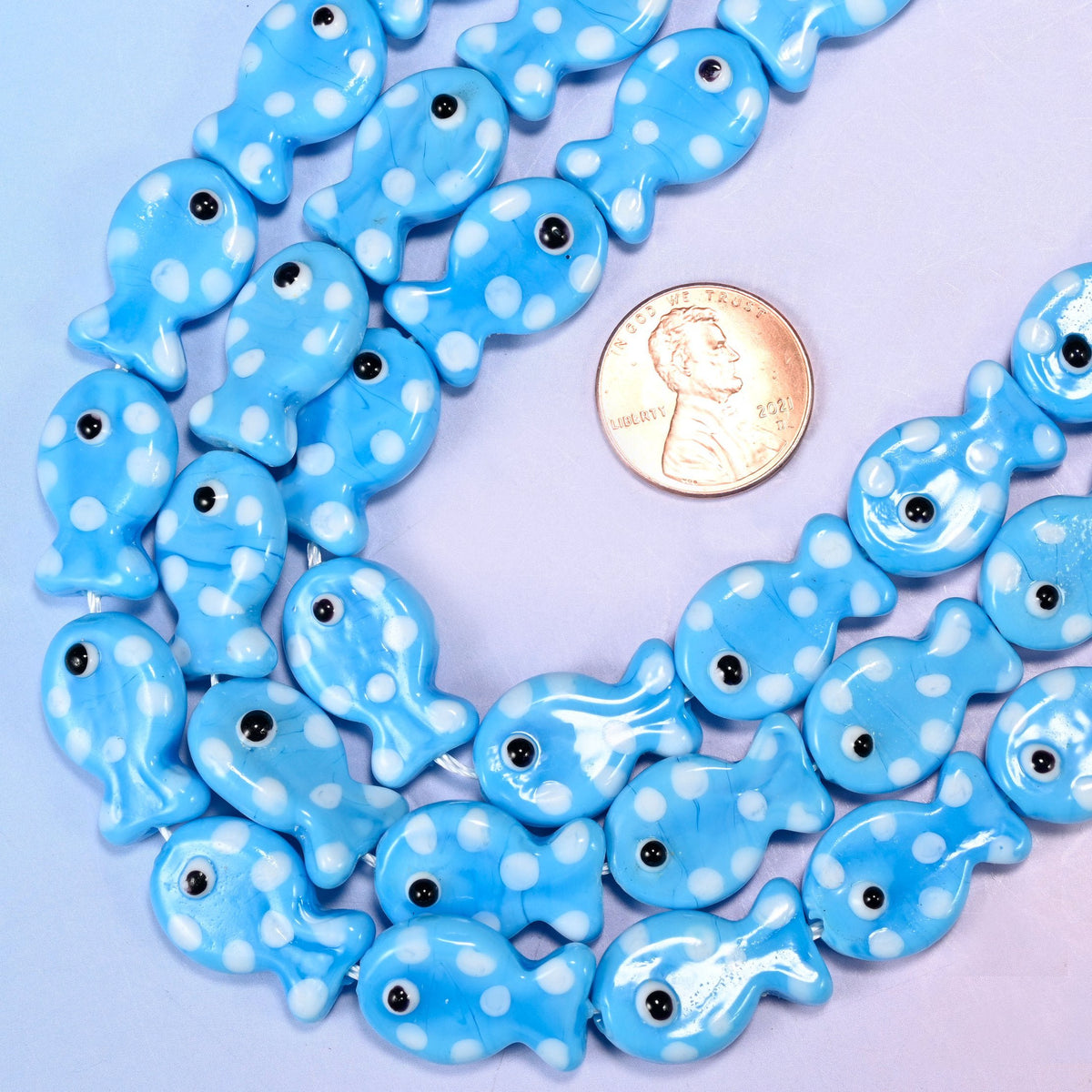 Fish-shaped sky blue glass beads with white dot pattern