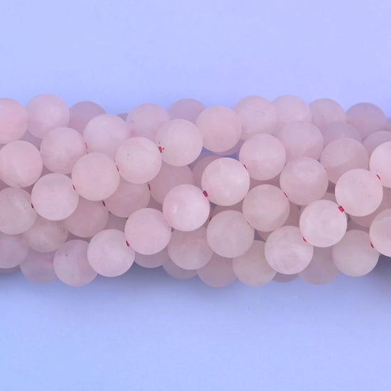 Pale blush pink sanded to a soft frosted finish, with milky cloud drifting through the larger beads