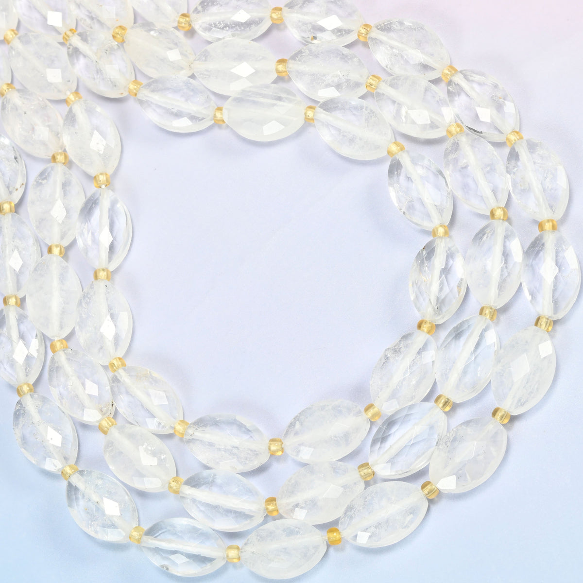 Clear quartz faceted flat oval beads curved into an open loop, clear and lightly cloudy quartz