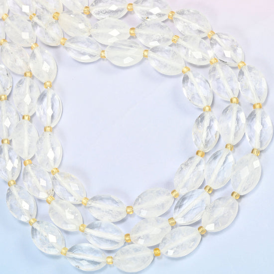 Clear quartz faceted flat oval beads curved into an open loop, clear and lightly cloudy quartz