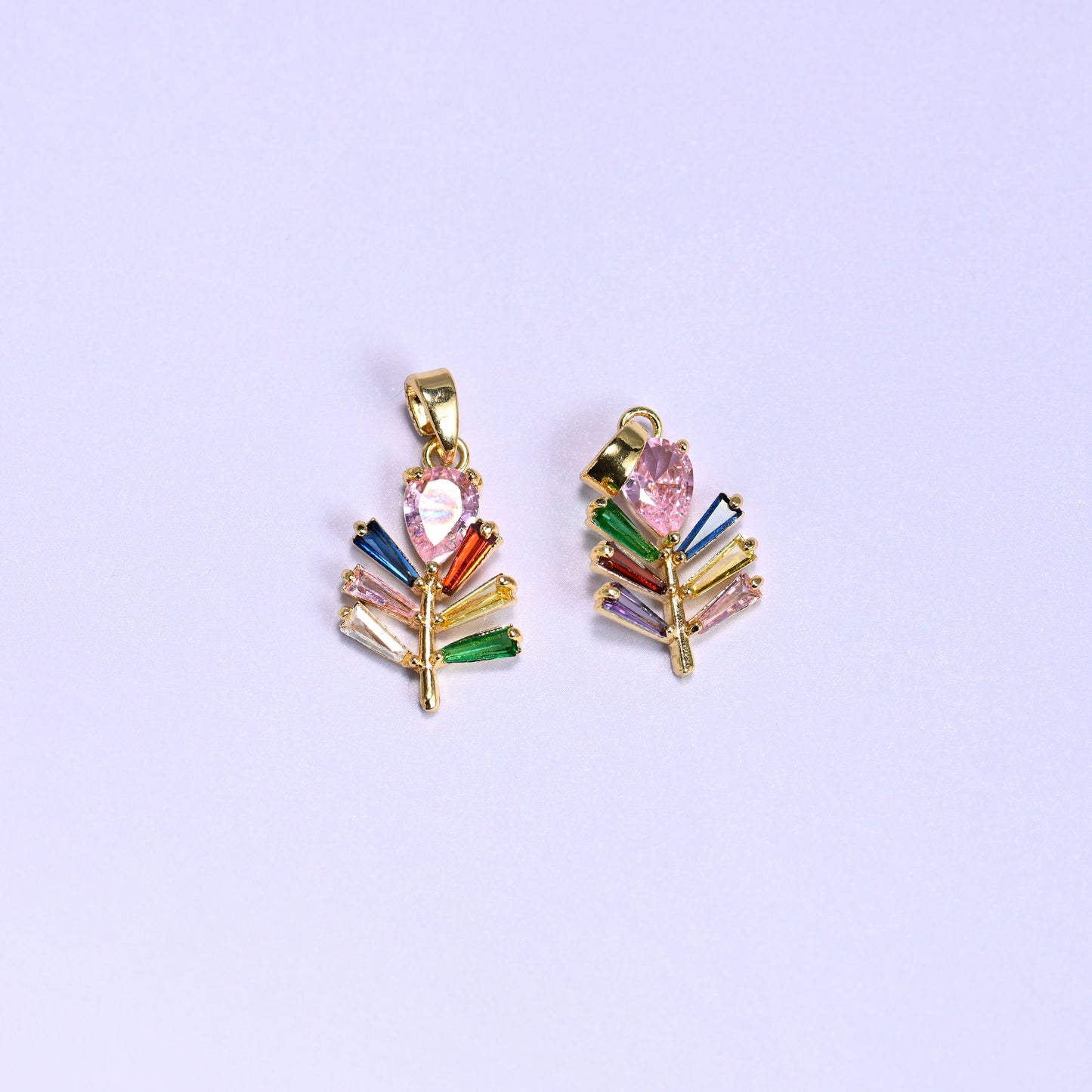 Leaf charm with multicolor baguette zircon veins fanning along a gold stem