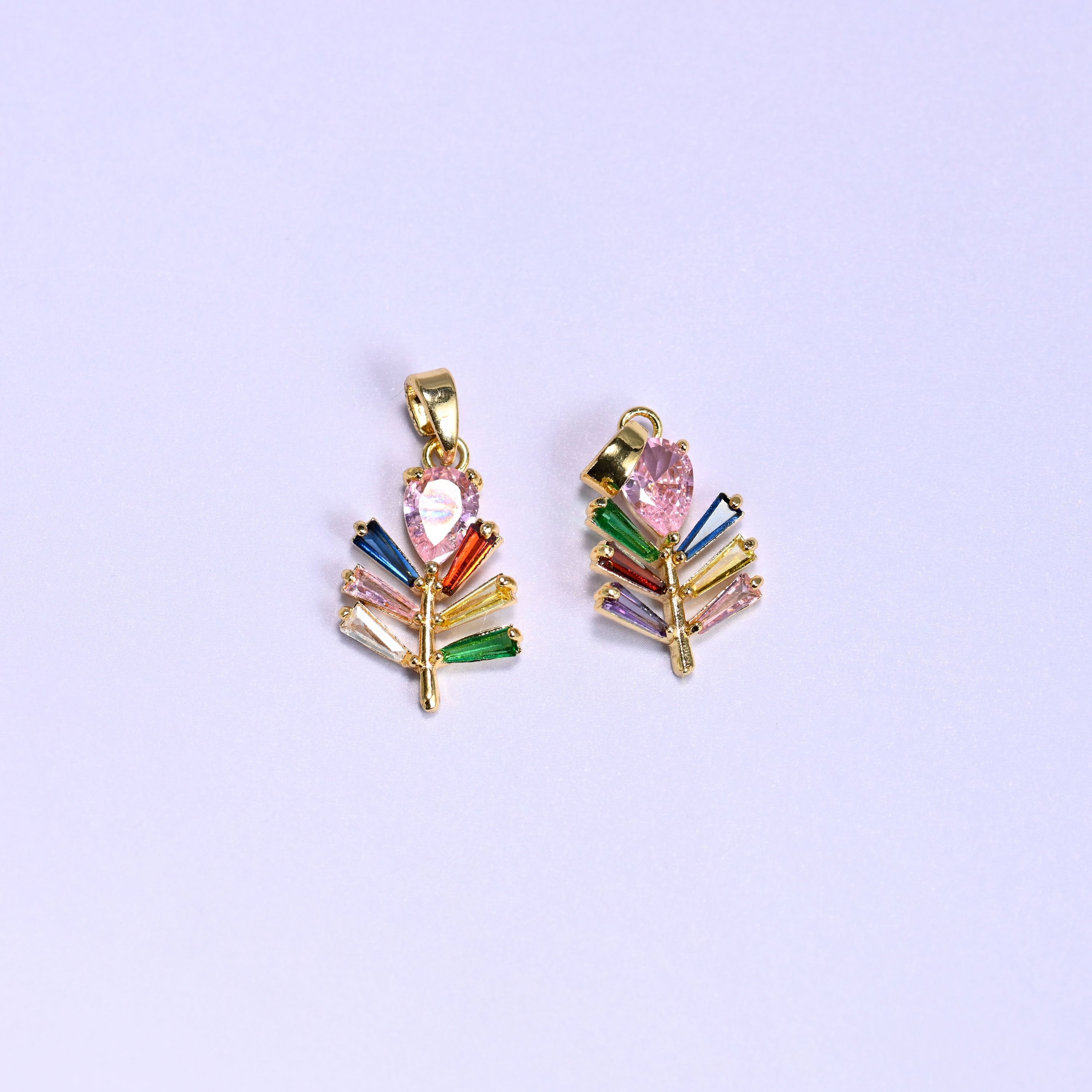 Leaf charm with multicolor baguette zircon veins fanning along a gold stem