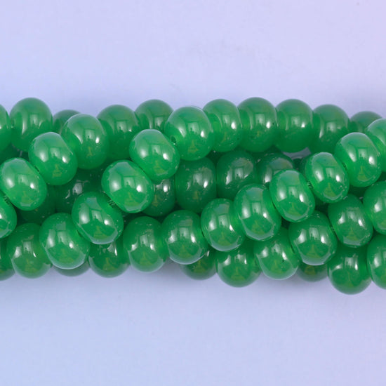 Smooth rondelle cut dyed jade beads with a polished surface