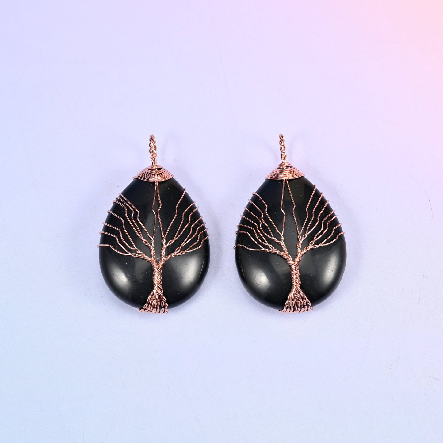 Teardrop Crystal Pendant with Copper Wired Tree in black obsidian, a matched pair where the copper branches stand out sharply against the glossy black.