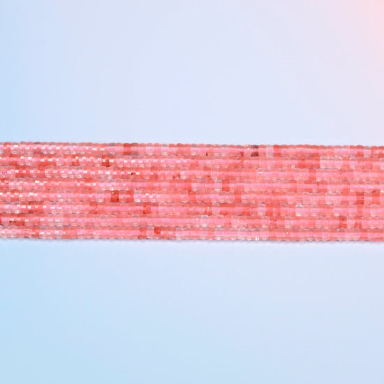 Several strands of melon quartz faceted heishi disc beads laid in straight rows