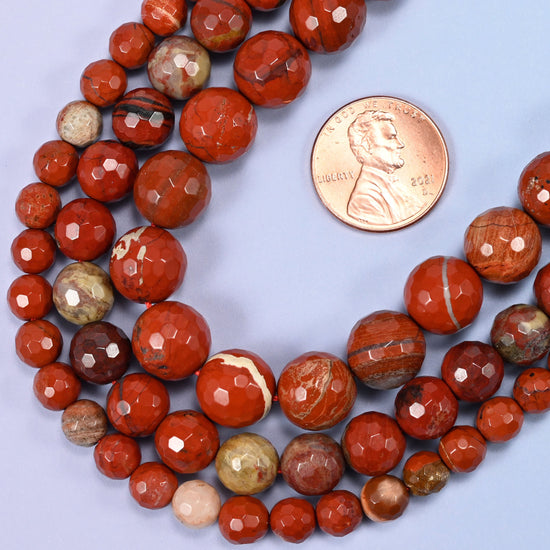 Flower red jasper round beads in 6mm, 8mm, and 10mm grouped together to compare sizes.
