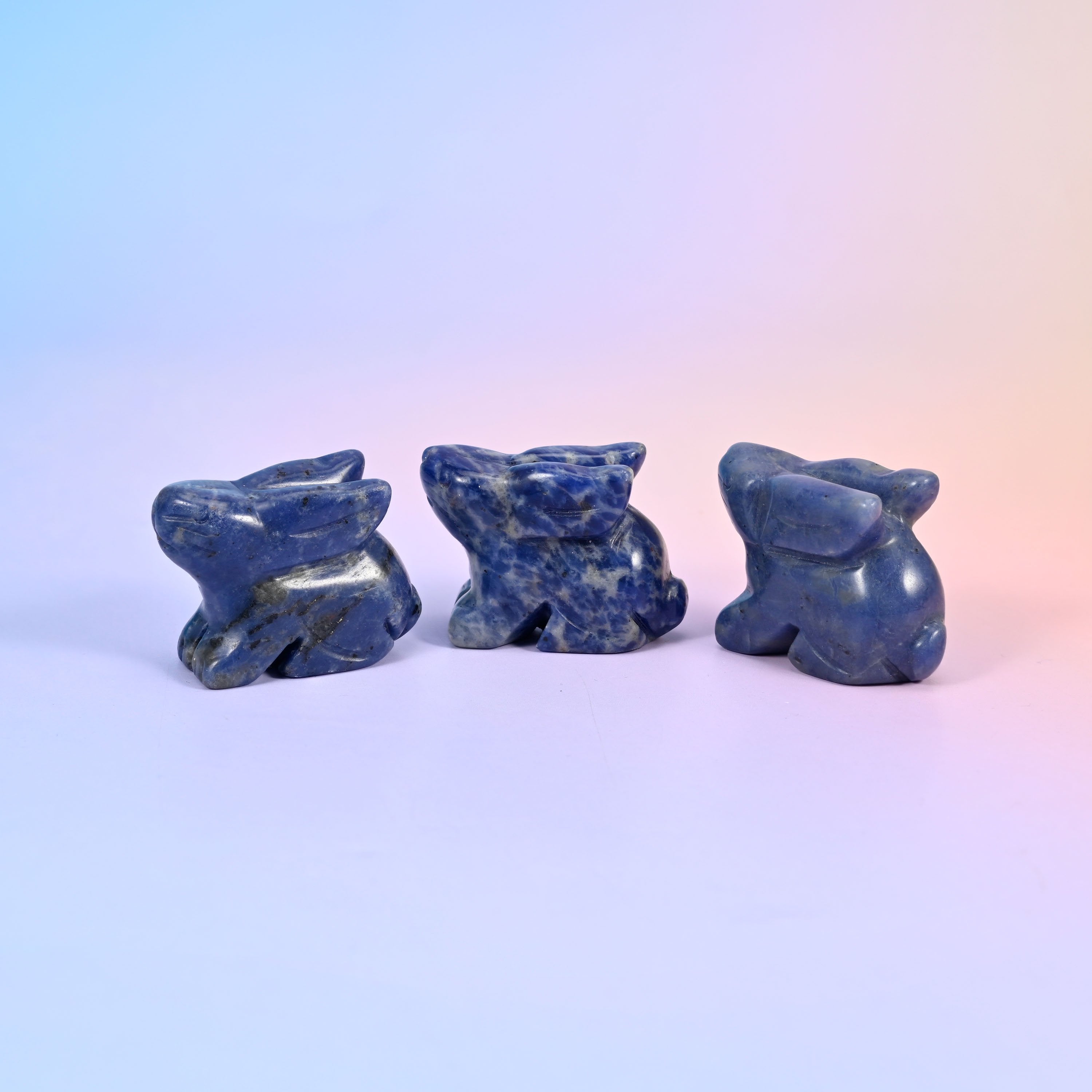 1.5 inch laying down bunny crystal figurine, carved with folded ears, tucked paws and a rounded tail