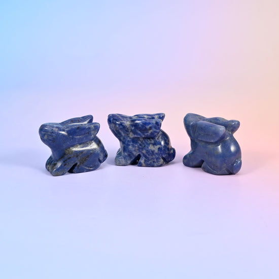 1.5 inch laying down bunny crystal figurine, carved with folded ears, tucked paws and a rounded tail