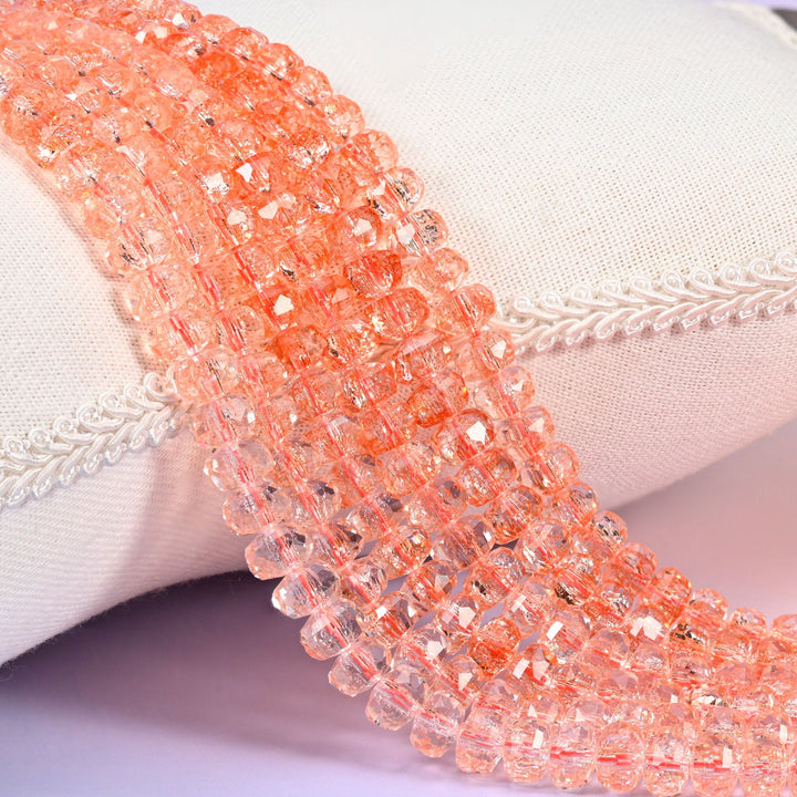 Transparent orange faceted rondelle glass beads in soft peachy coral, clear enough to see through