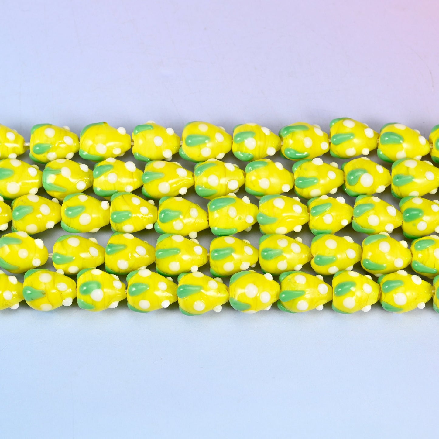 Yellow White Dots Strawberry Glass Beads in bright lemon-yellow with a green leaf panel