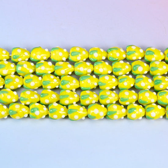 Yellow White Dots Strawberry Glass Beads in bright lemon-yellow with a green leaf panel