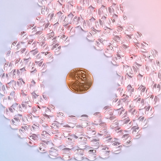Clear pink pumpkin glass beads coiled into a wide open ring, the fluted grooves catching the light.
