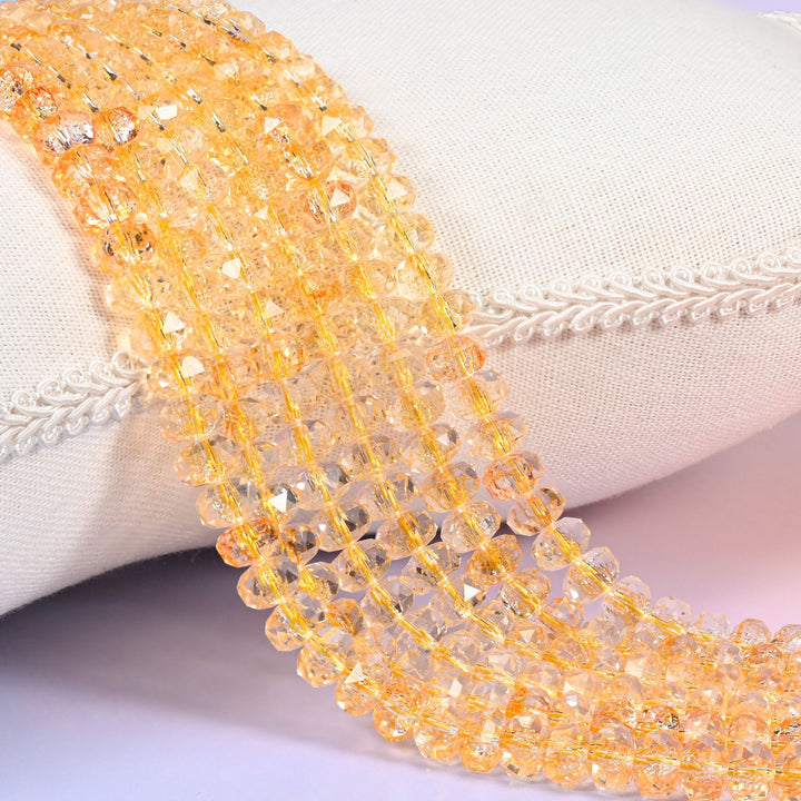 Transparent gold faceted rondelle glass beads in warm champagne and amber gold, clear enough to see through