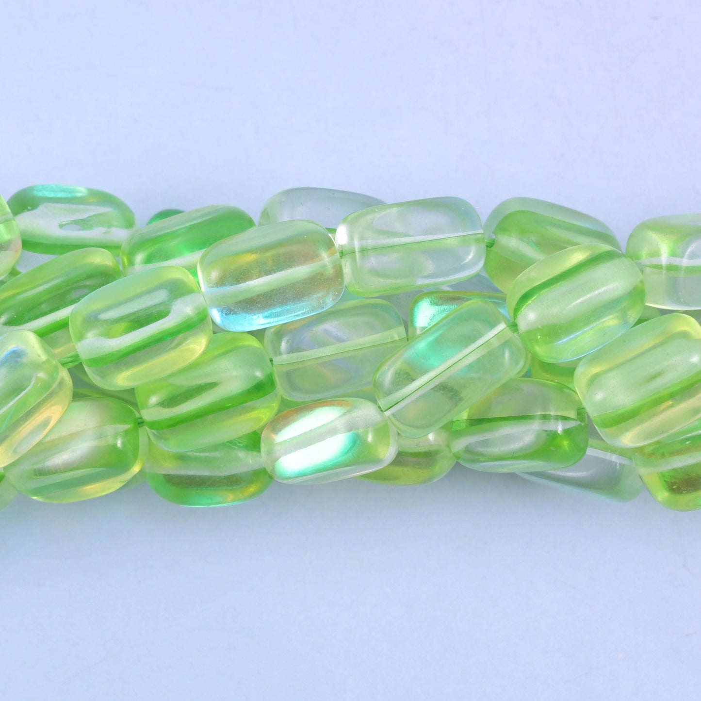 Rectangular cut glass beads with a glossy transparent finish and iridescent mystic aura coating