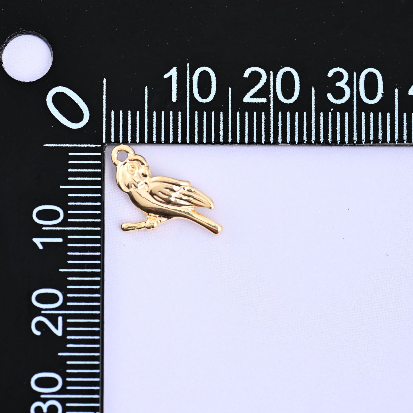 Small gold charms bird on a millimeter ruler showing the 9.1mm height, 18K gold plated