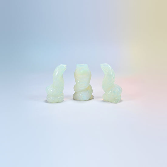 Cobra snake carving in opalite, milky white man-made glass with a blue glow
