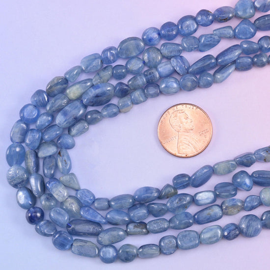 Kyanite nugget strands looped around a US penny to give a sense of the 5-8mm bead scale