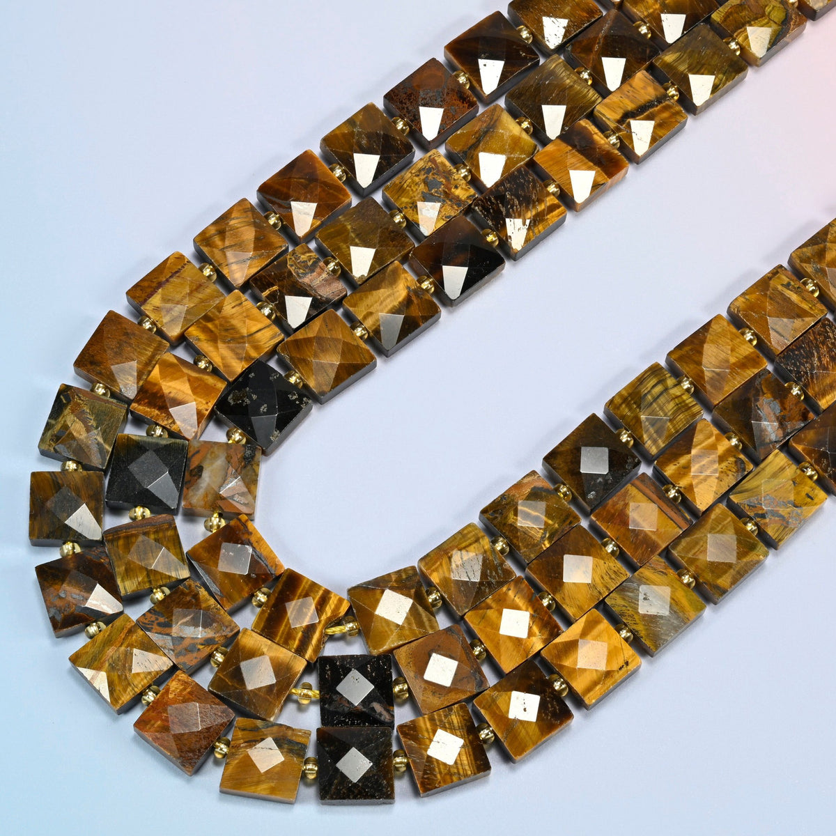 Natural tiger eye faceted flat square beads in several strands curved into a wide U, golden brown stone with a silky shimmer