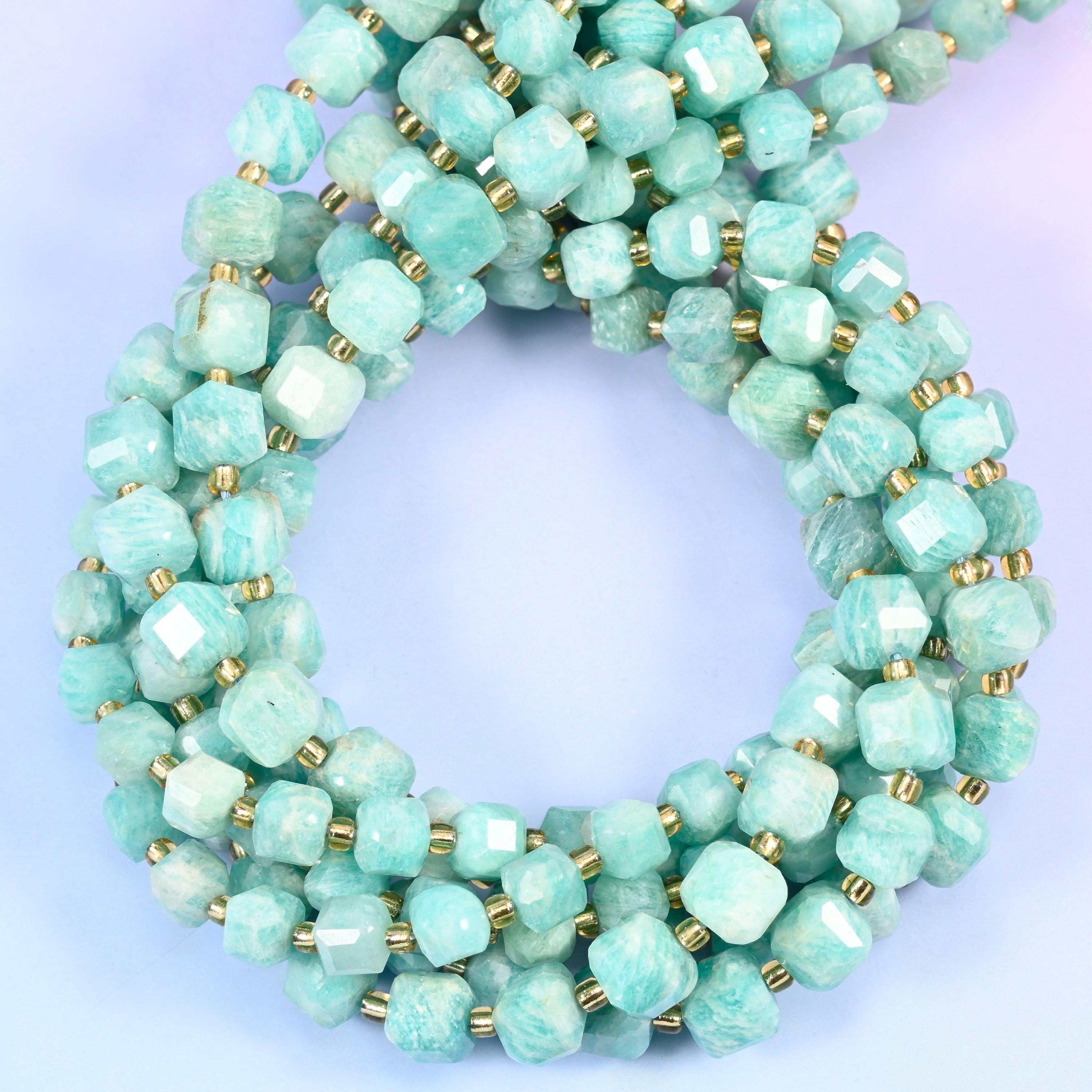 Pale mint and seafoam stone swirled with chalky white cloud patches, squared into cubes with every corner cut back so the soft colour picks up a bright edge on each face.