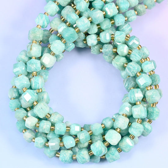 Pale mint and seafoam stone swirled with chalky white cloud patches, squared into cubes with every corner cut back so the soft colour picks up a bright edge on each face.