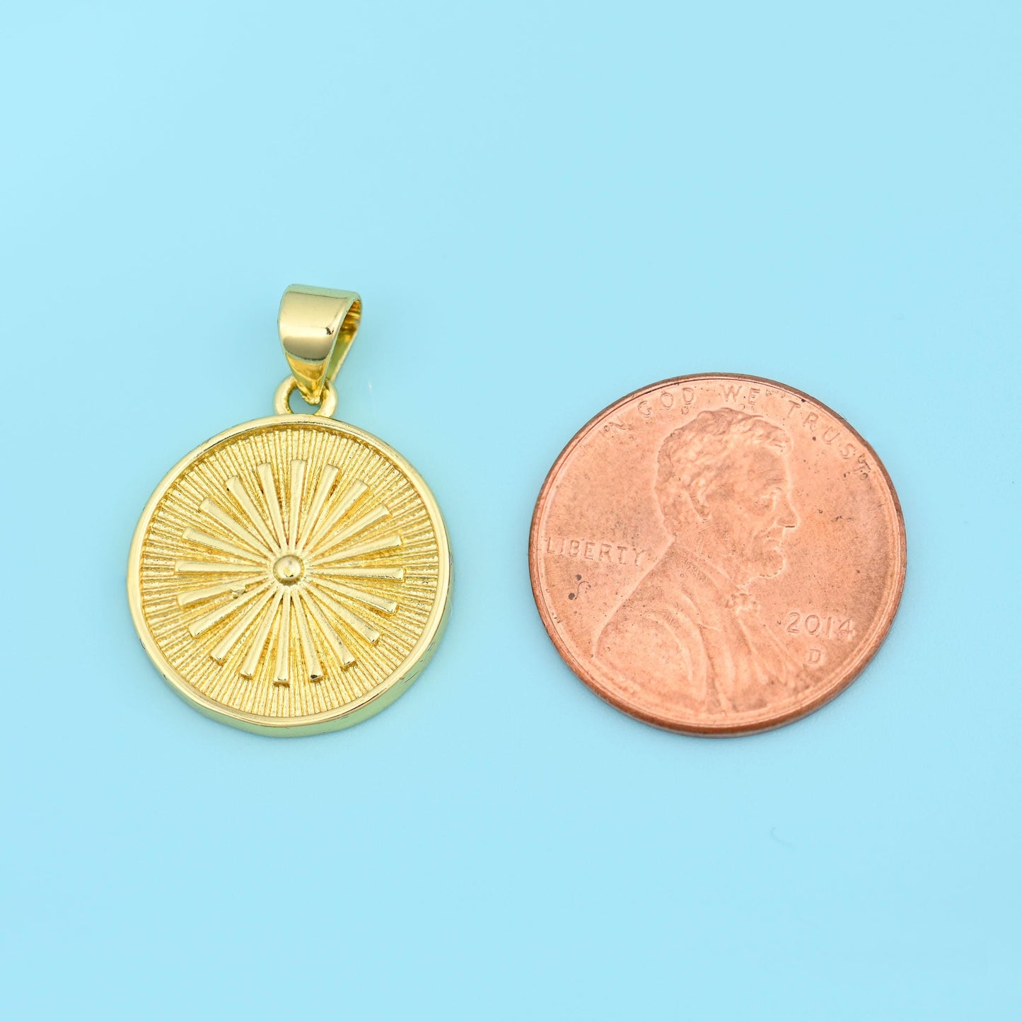 A round disc engraved with fine rays fanning out from a raised centre point, the reverse left plain and slightly textured,…