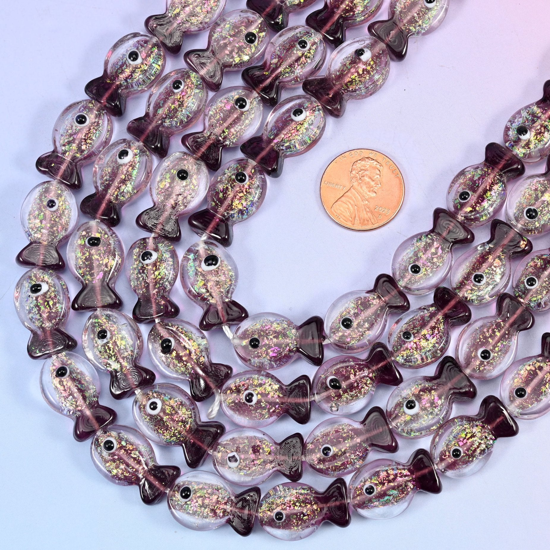 Fish shaped purple glass beads with a deep plum tail
