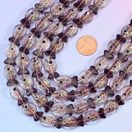 Fish shaped purple glass beads with a deep plum tail
