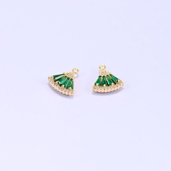 Small gold charms, two fan charms with green cubic zirconia shown close up