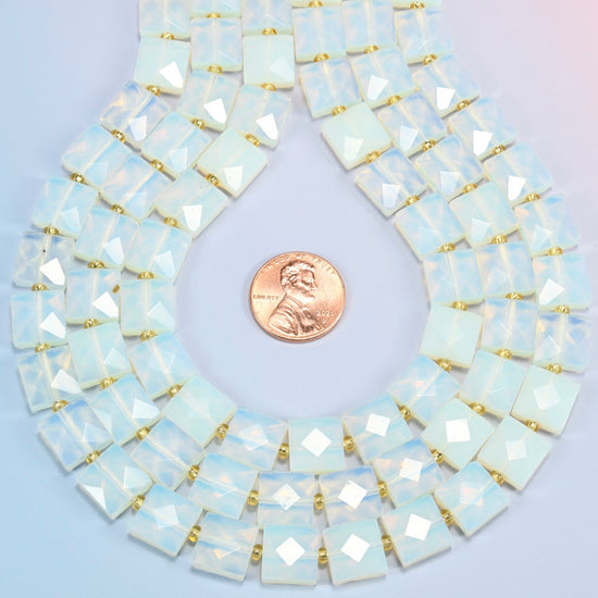 Opalite faceted flat square strands formed into a teardrop loop around a US penny for scale