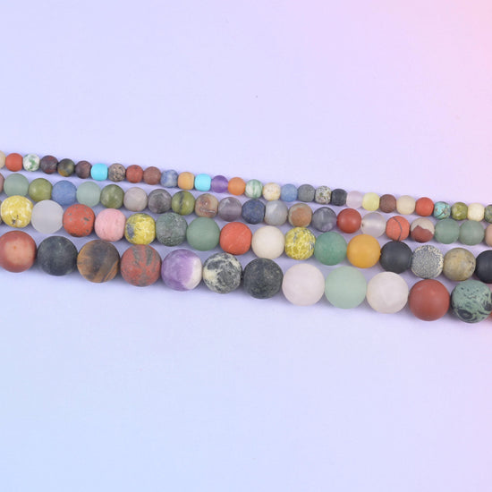Four strands of matte rounds in 4mm, 6mm, 8mm and 10mm sizes side by side
