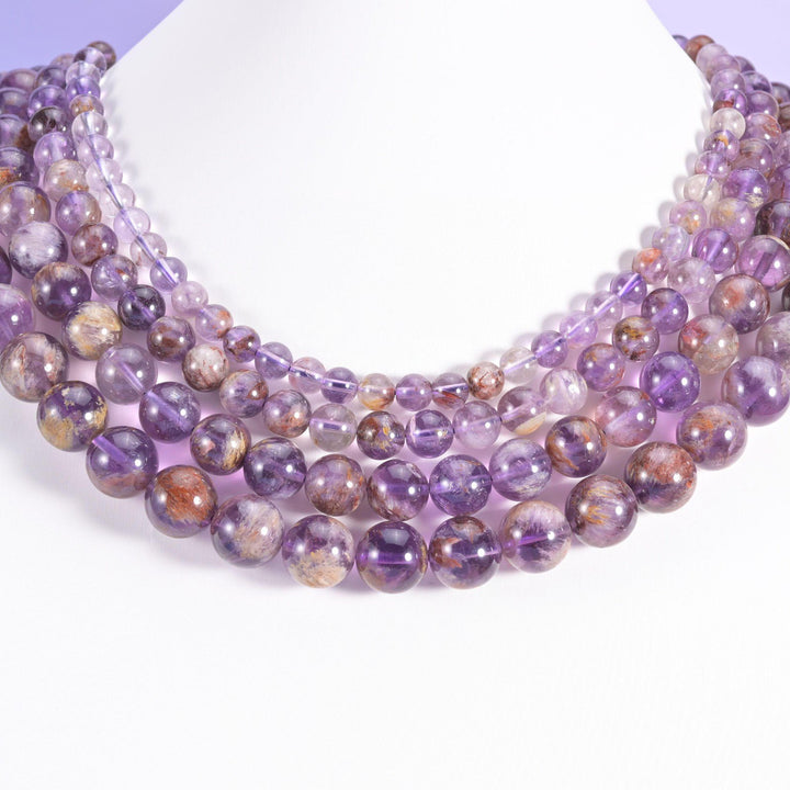 Super 7 Purple Phantom round beads looped around a white neck display form, strands in 6mm, 8mm, 10mm and 12mm