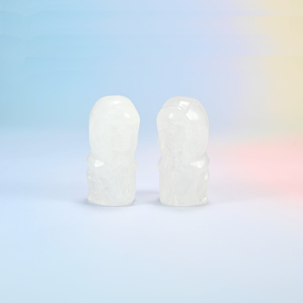 Two natural clear quartz hooded skull carvings, milky white with see-through edges