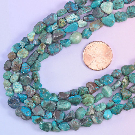 Strands looped beside a US penny, giving scale for the 6-8mm irregular nuggets