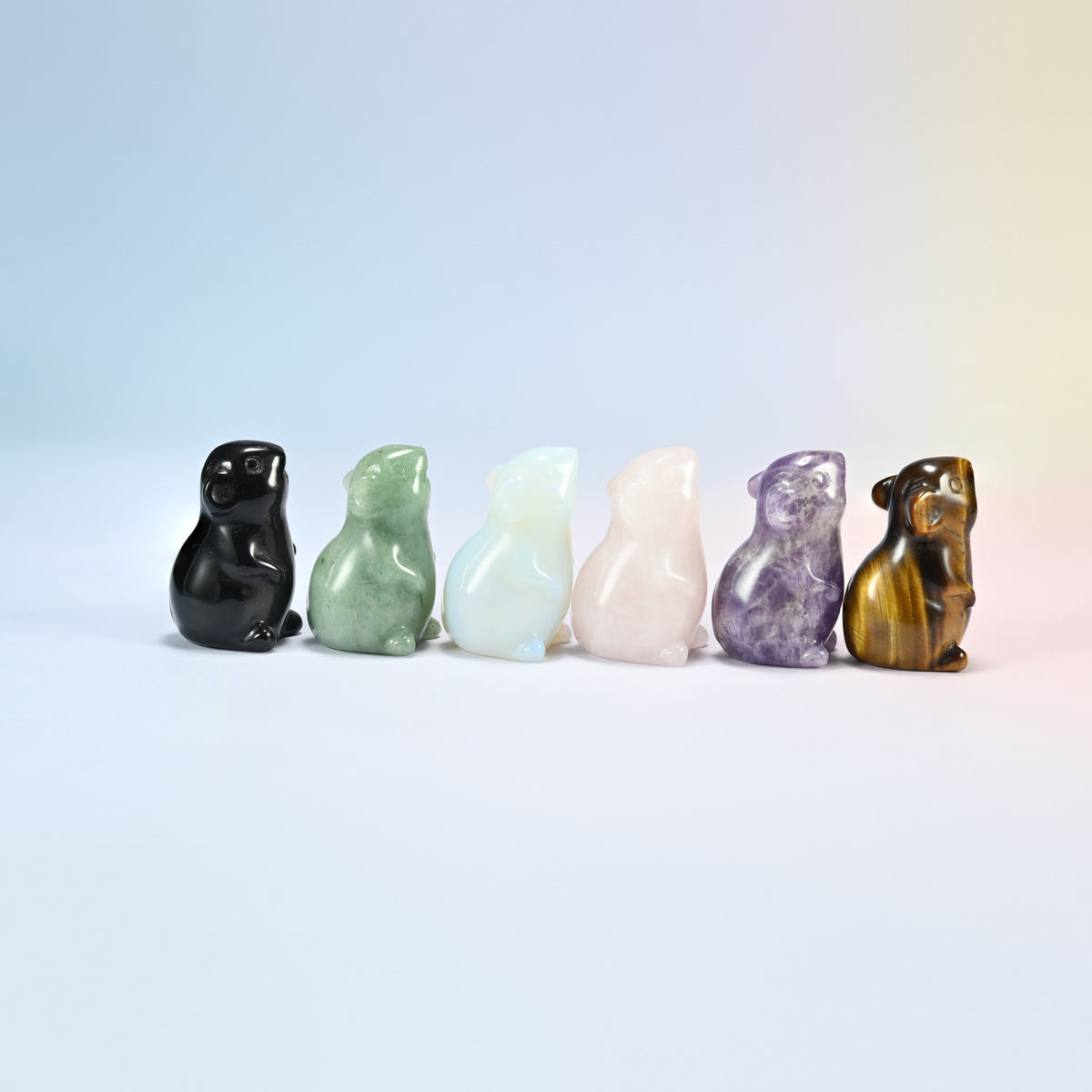 Side view of six gemstone mouse figurines sitting up on their back legs