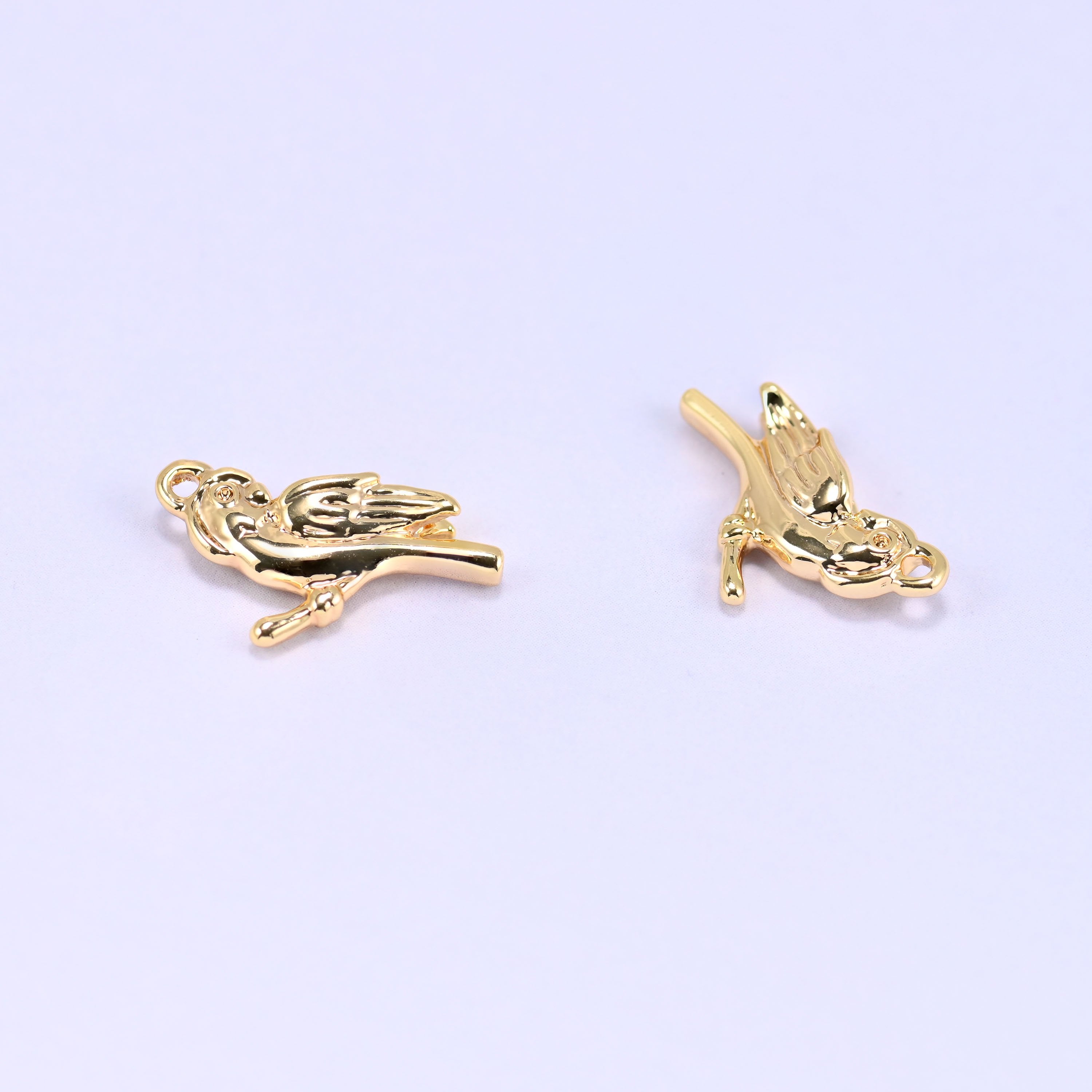 Small gold charms bird, two charms angled to show the feather detail on both sides