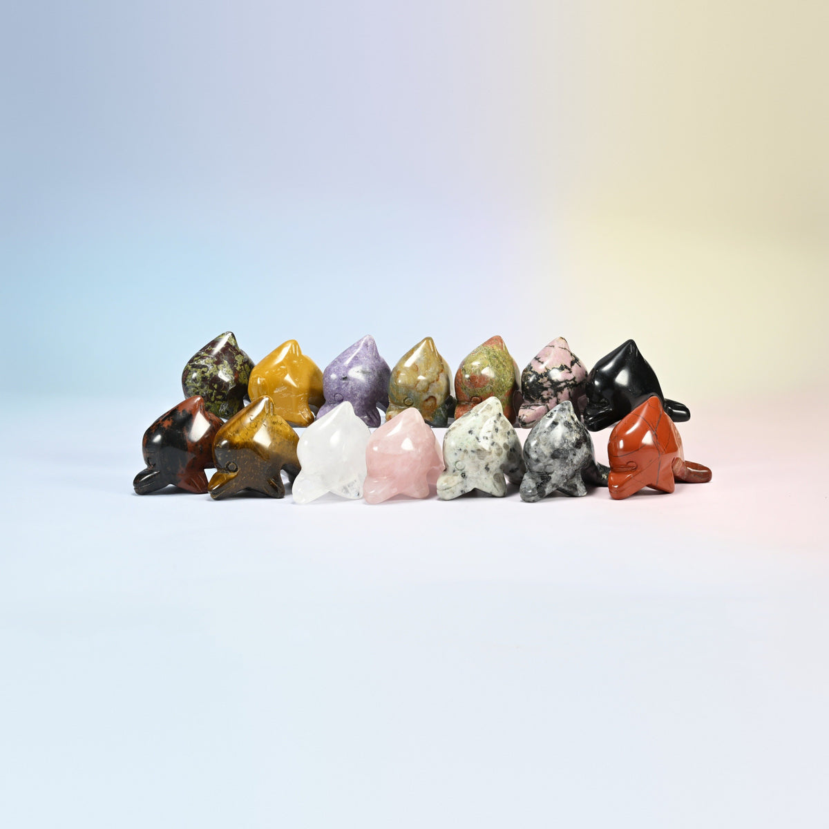 Group of dolphin crystal carvings in 1.5 and 2 inch, natural rhodonite, mookaite, unakite, red jasper, rose quartz, clear quartz, black obsidian and more
