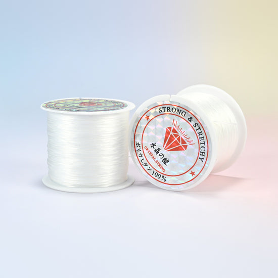 Two rolls of clear 0.7-0.8mm elastic stretch string, glossy polyurethane bead cord with a holographic label