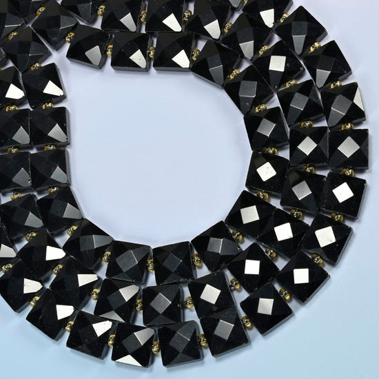 Natural black onyx faceted flat square beads curved into an open loop, glossy black beads