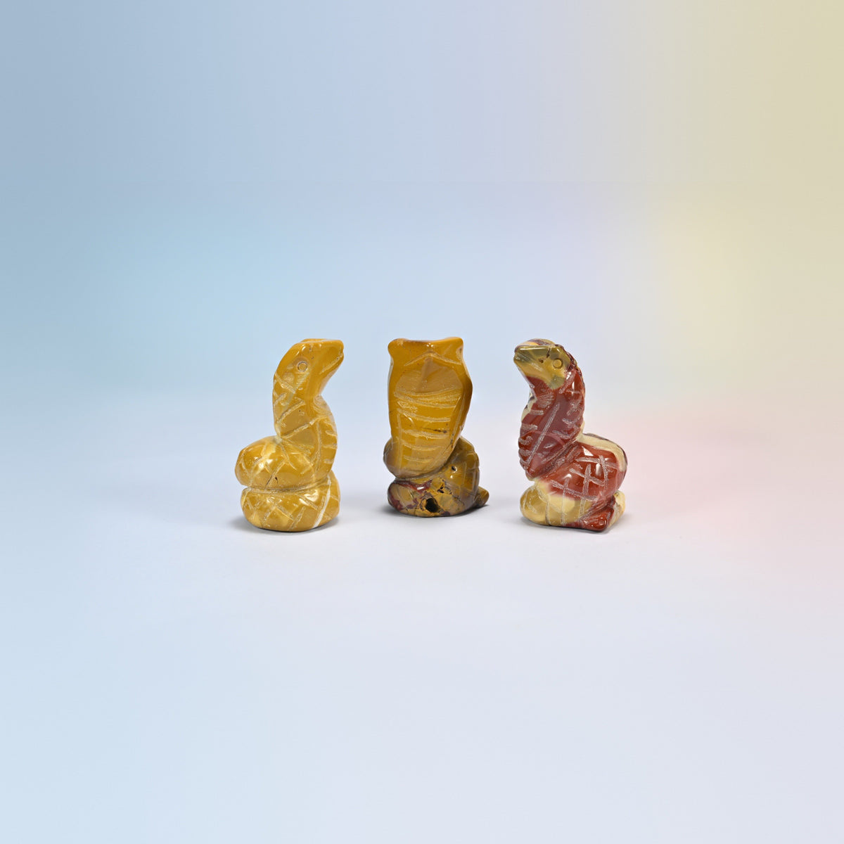 Cobra snake crystal carving in mookaite, natural stone in golden yellow, red and cream