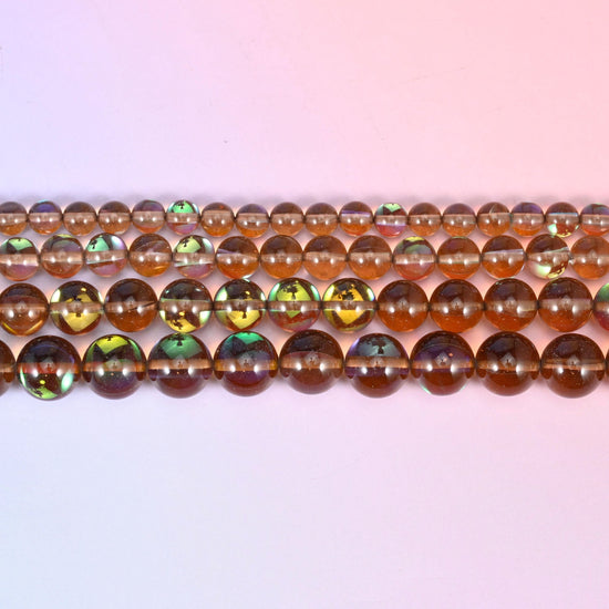 Mystic Aura Brown Round Glass Beads in clear smoky brown with a peacock-green and gold iridescent panel