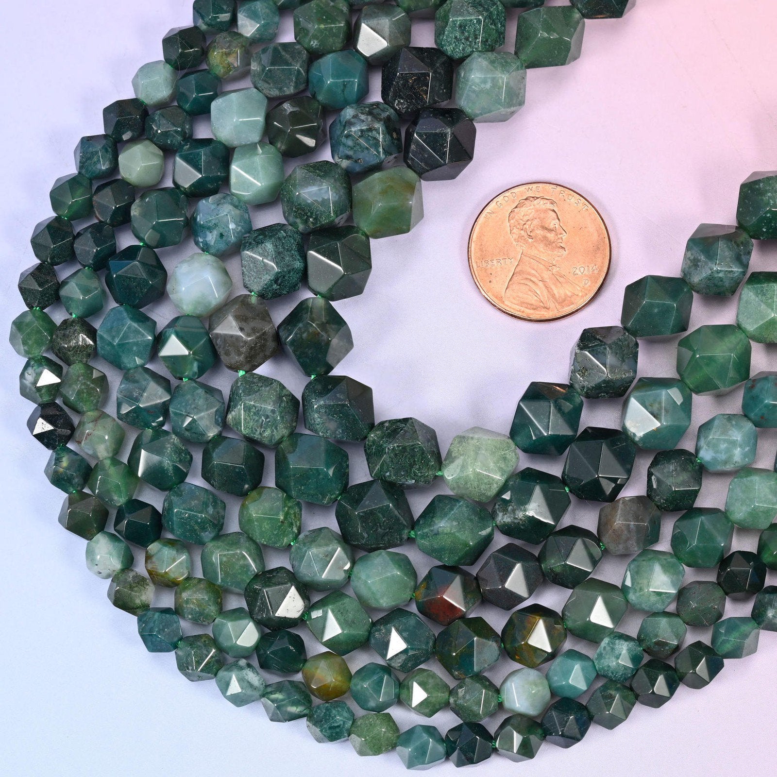 Moss Agate star cut beads with a US penny alongside for size reference, available in 6mm, 8mm and 10mm