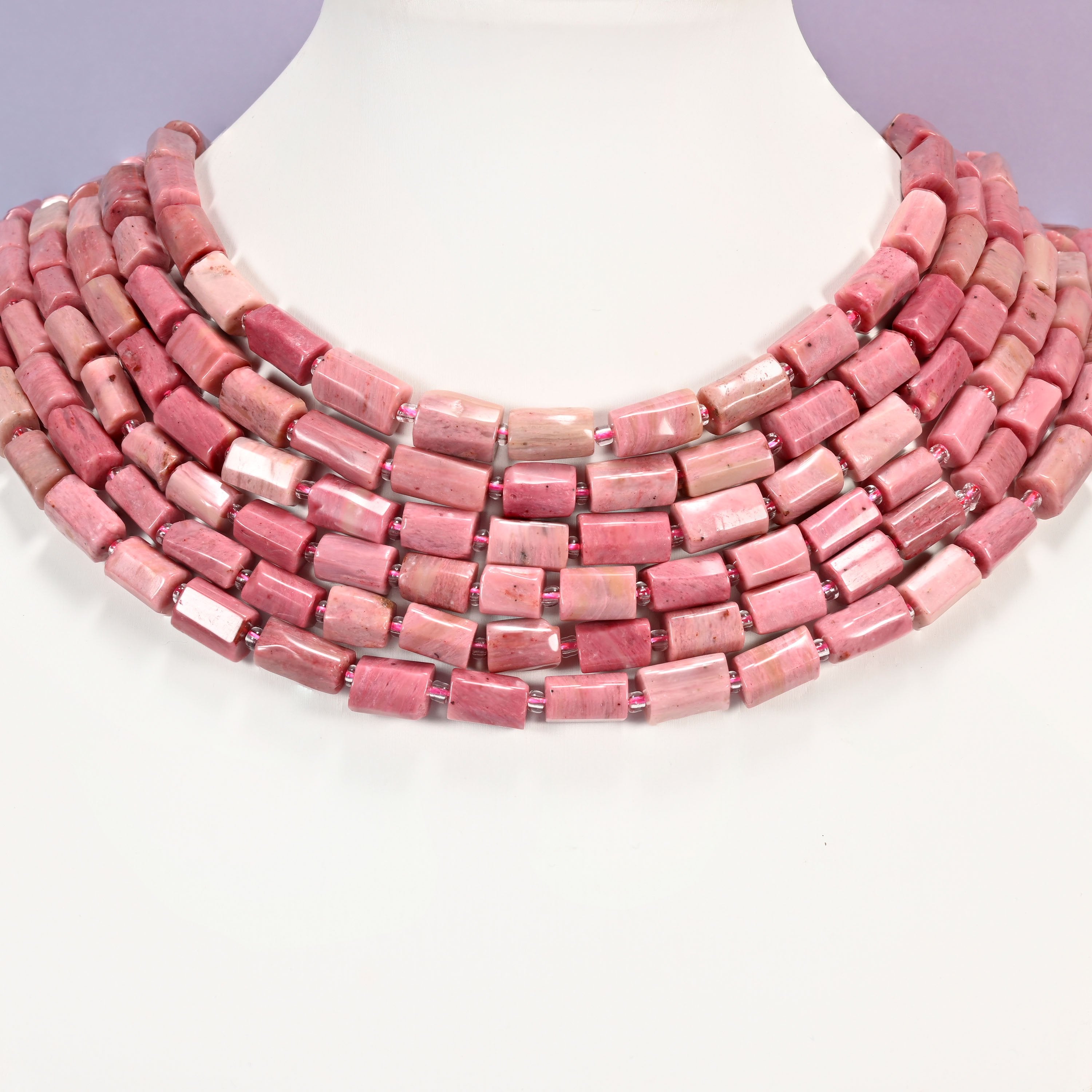 Pink Rhodonite faceted tube beads laid in four graduated collar rows, 9x7mm to 11x7mm soft pink tubes with cream veining