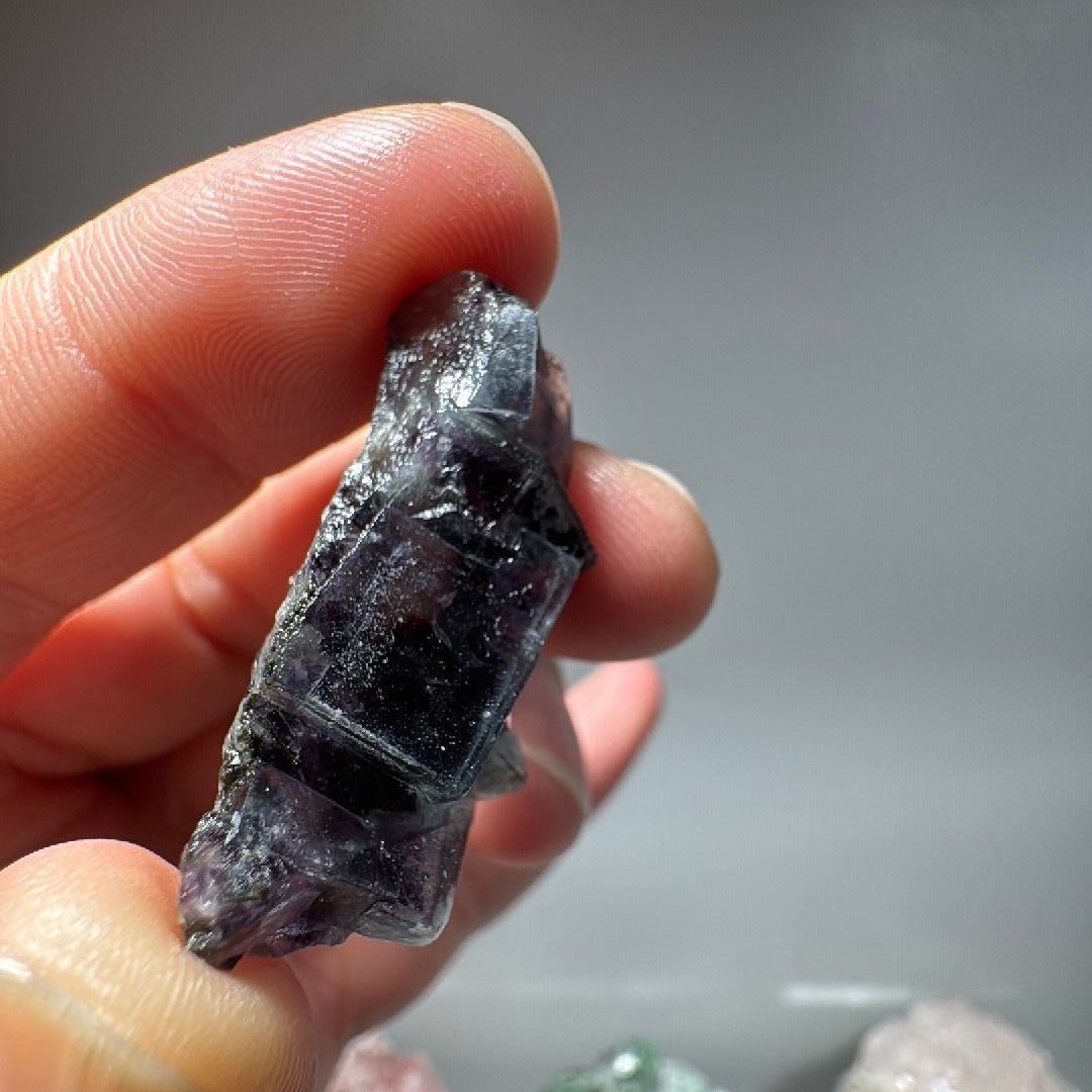 The piece rotated to show its depth, purple banding visible inside the translucent cubes