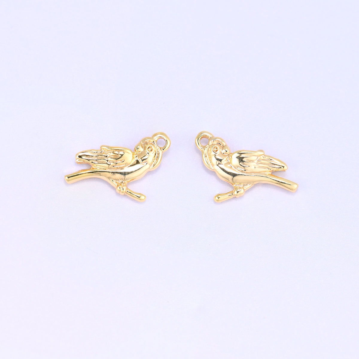 Small gold charms bird, two 18K gold plated charms side by side showing the double sided design