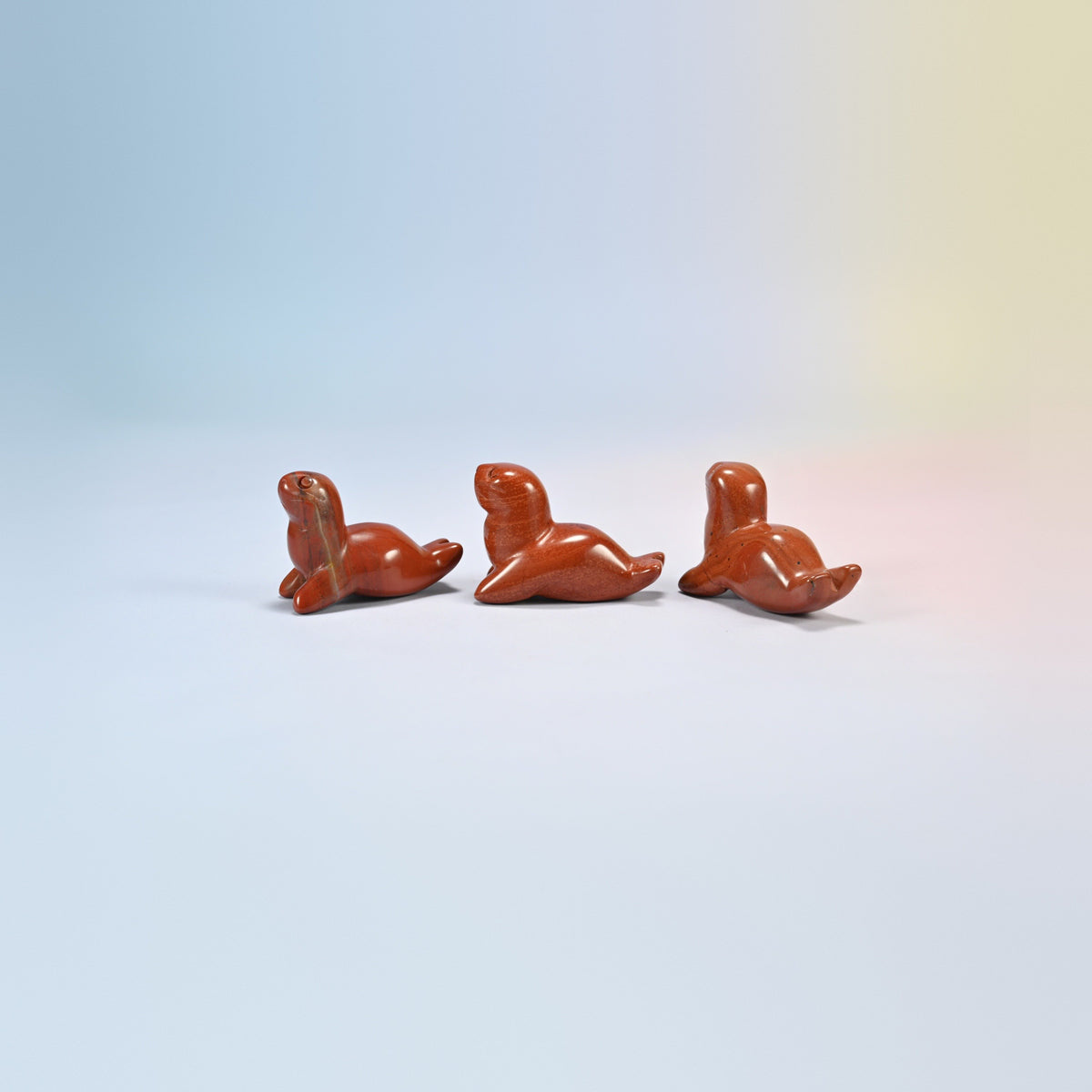 Three red jasper sea lion crystal carvings, 1.5 inch, brick red natural stone