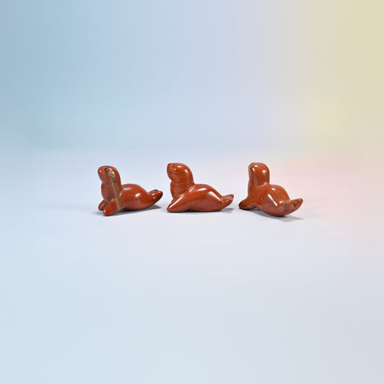 Three red jasper sea lion crystal carvings, 1.5 inch, brick red natural stone